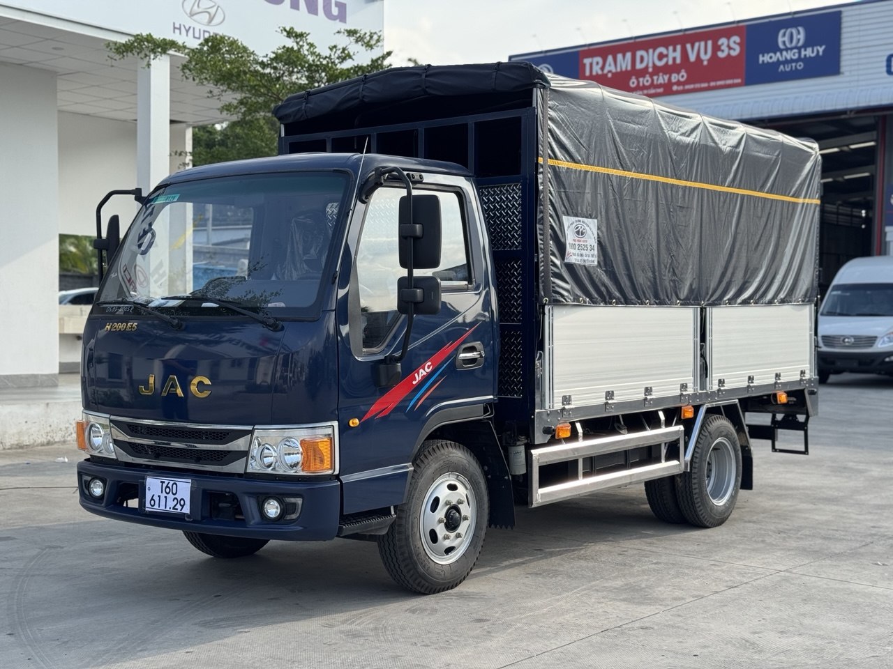 Xe tải JAC H200 EURO 5 thùng mui bạt màu xanh đậm từ góc 3/4 phía trước bên trái